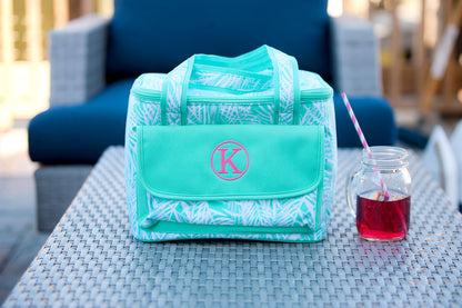 Personalized palm-print cooler bag beside a cold drink