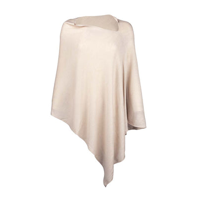 Cream Chelsea poncho with asymmetrical hem on a white background