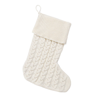 Cream cable knit Christmas stocking with folded ribbed cuff on white
