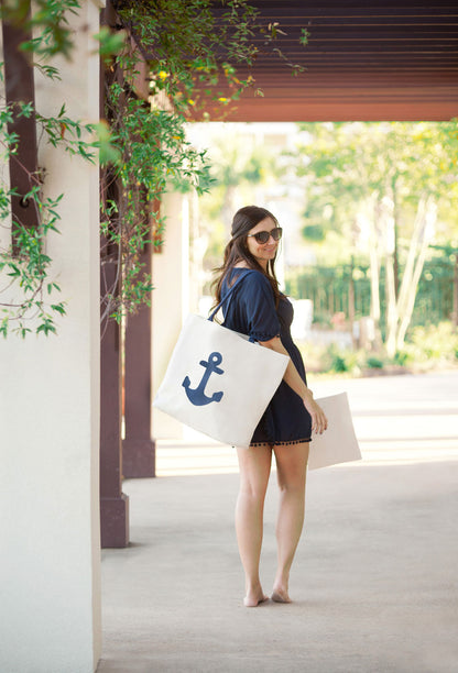 Woman carrying a navy anchor tote over the shoulder outdoors