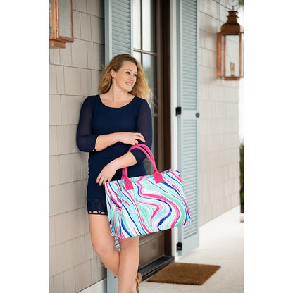 Woman seated with a colorful swirl-print tote