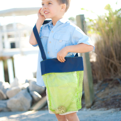 Child carrying a green mesh tote with a navy top panel