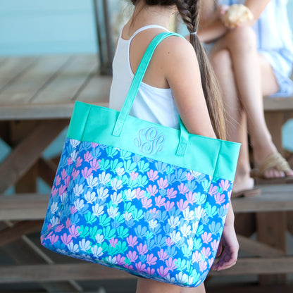 Close-up of a mermaid-tail-print tote with mint panel and monogram