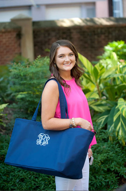 Woman holding a navy oversized tote outdoors